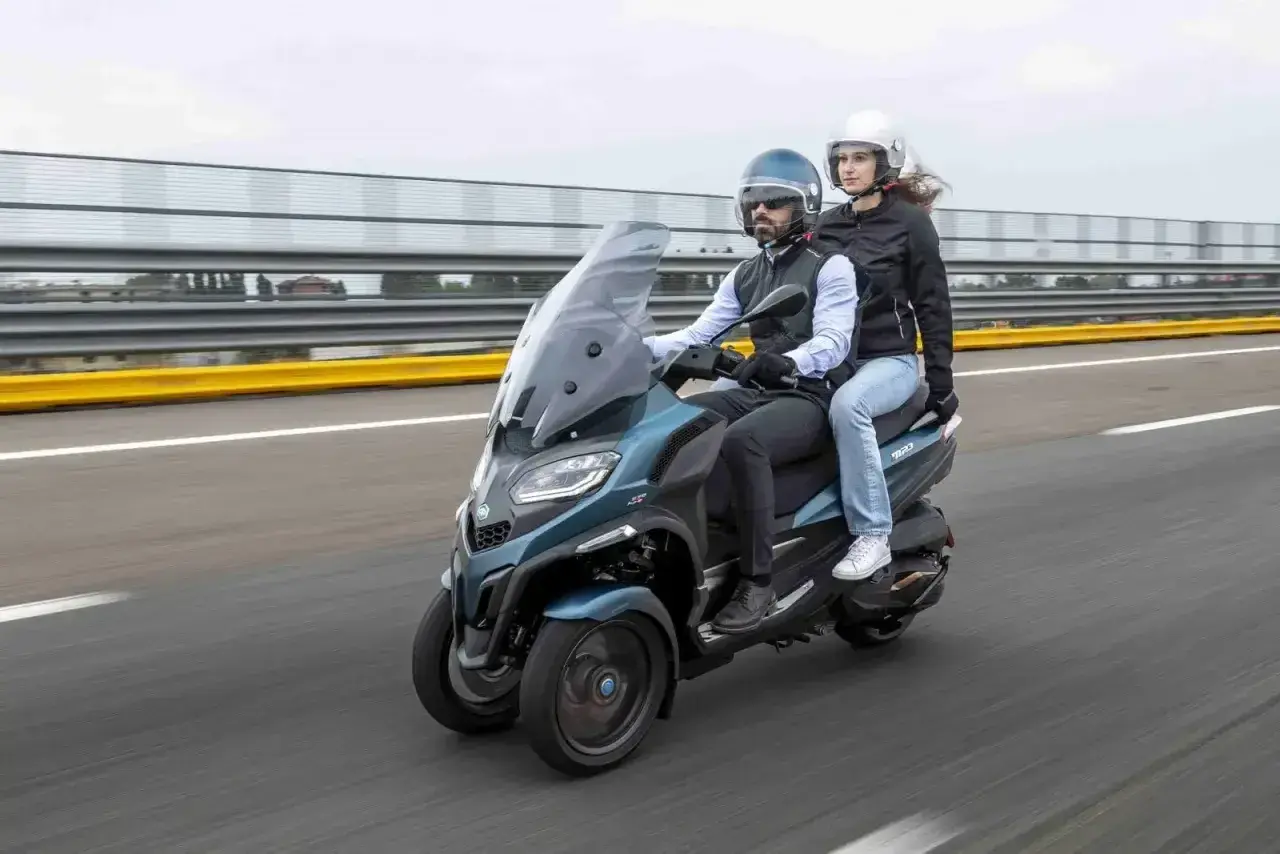 Para jadąca na Piaggio MP3 500, testująca jego prędkość maksymalną na torze wyścigowym.