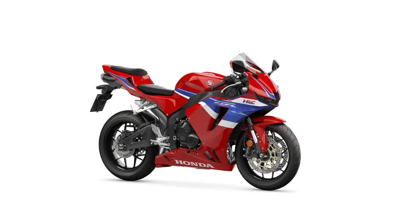 Czerwony motocykl sportowy Honda CBR 600 z niebieskimi i białymi pasami. Poznaj honda cbr 600 dane techniczne.