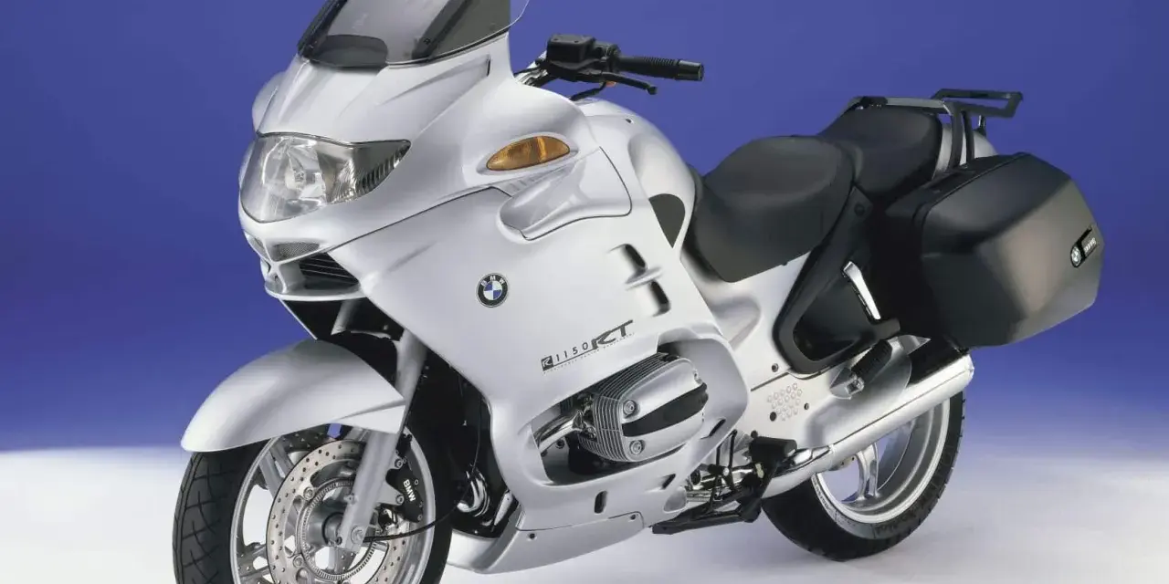 Srebrny motocykl BMW R1150RT z kuframi. Poznaj jego bmw rt 1200 dane techniczne i możliwości.