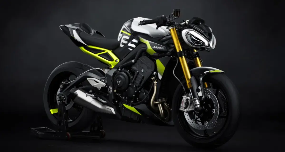 Agresywny Triumph Street Triple w biało-czarnej kolorystyce z neonowo-żółtymi akcentami, zdominowany przez złote lagi i sportowy wygląd.