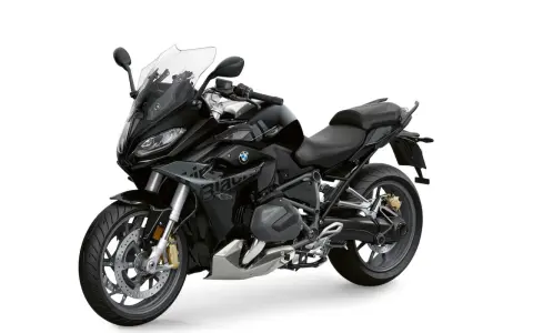 Czarny motocykl BMW 1250 RS z przyciemnianą szybą i sportowym wyglądem, gotowy na każdą podróż.