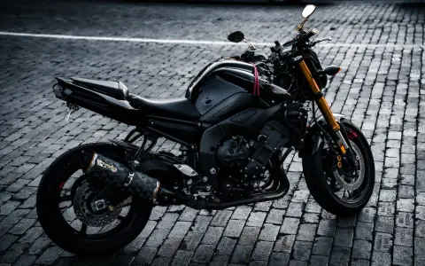 Czarny motocykl na bruku, idealny na giełda motocykli używanych Niemcy. Gotowy do jazdy po niemieckich drogach.
