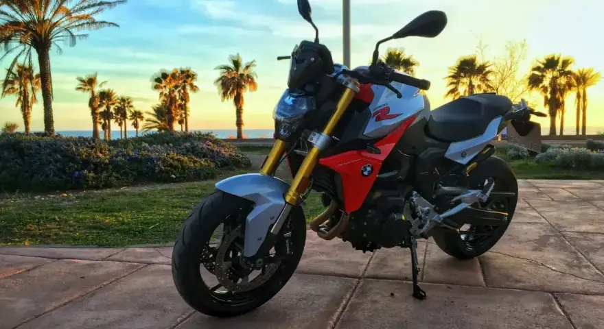 BMW F900XR na tle palem i zachodzącego słońca. Idealny motocykl na wakacyjne podróże.