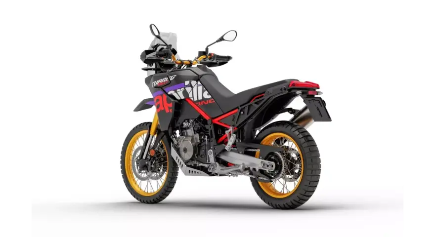 Czarny motocykl Aprilia Tuareg 660 z czerwonymi i fioletowymi akcentami, złote felgi. Dane techniczne tego modelu są imponujące.